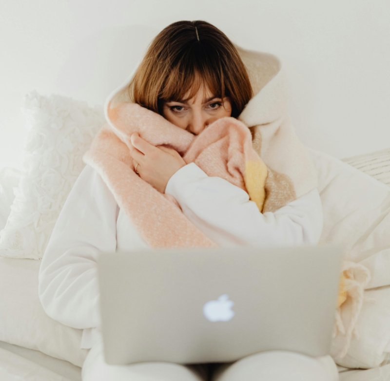 cold woman bundled in blanket