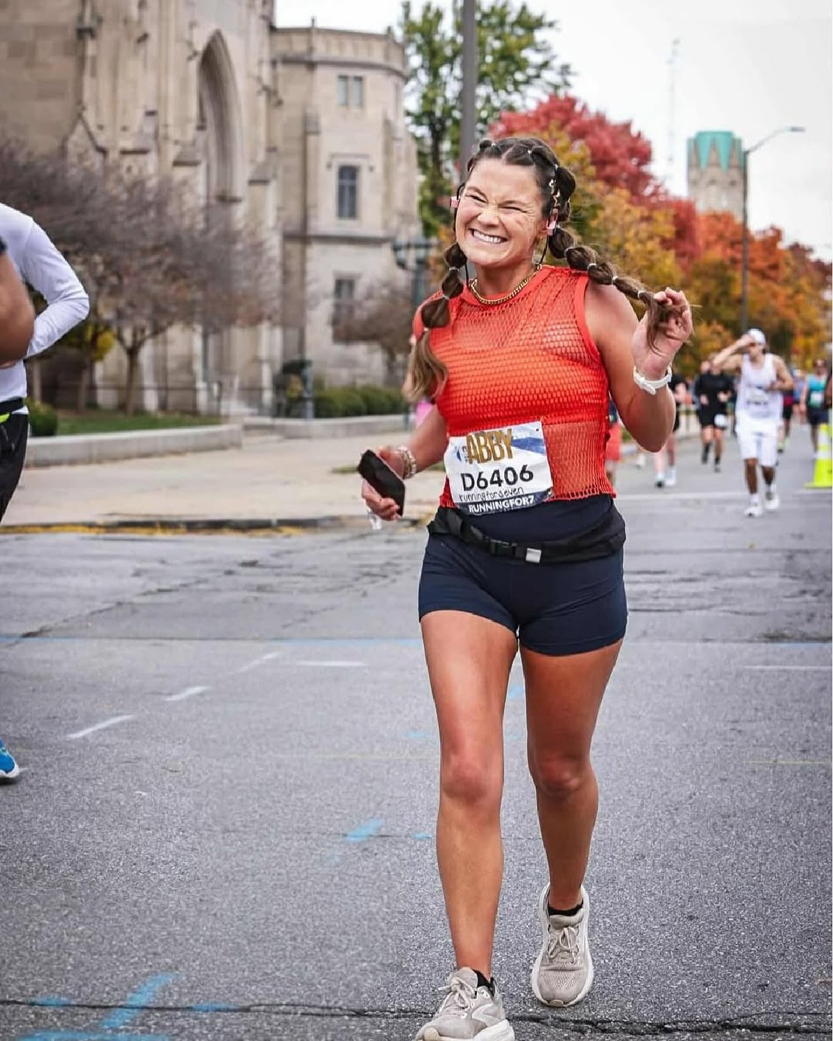 smiling woman walking Indy Monumental
