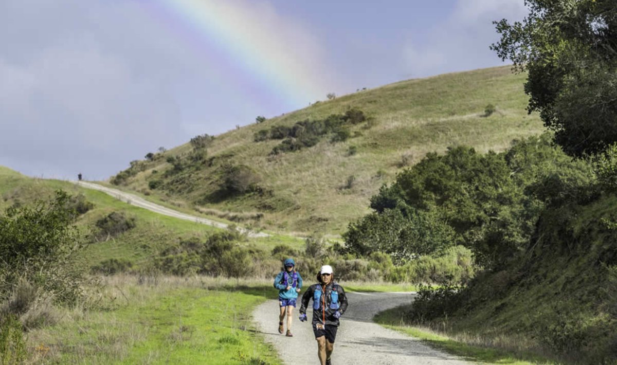 runners at Fort Ord state park under a rainbow