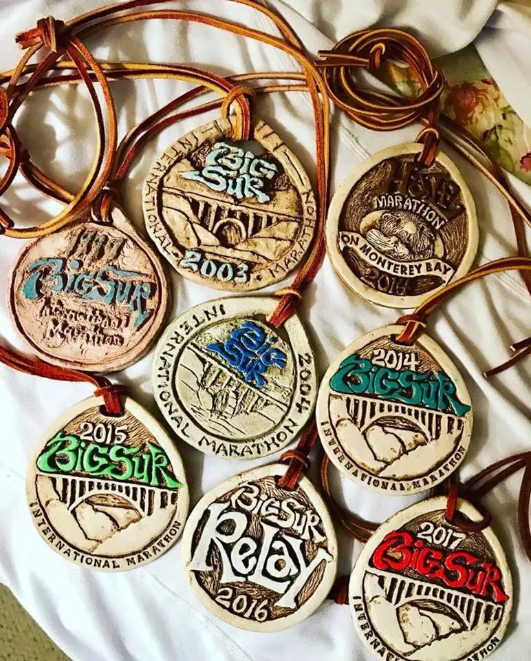 A group of Big Sur medals on a bed.